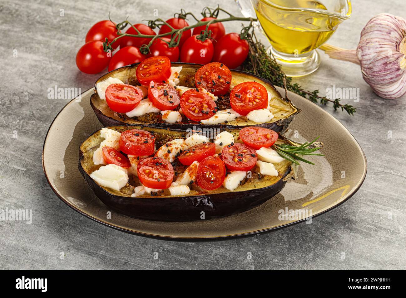 Baked eggplant with mozzarella cheese and tomato Stock Photo - Alamy