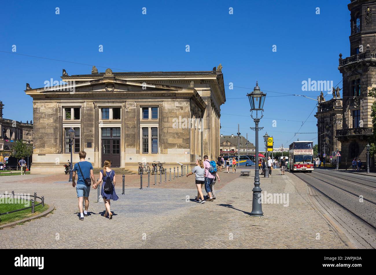 Tourist situation and approaching double-decker bus for sightseeing tours between New Main Guardhouse and Residential Palace, Dresden, Saxony, Germany. Stock Photo