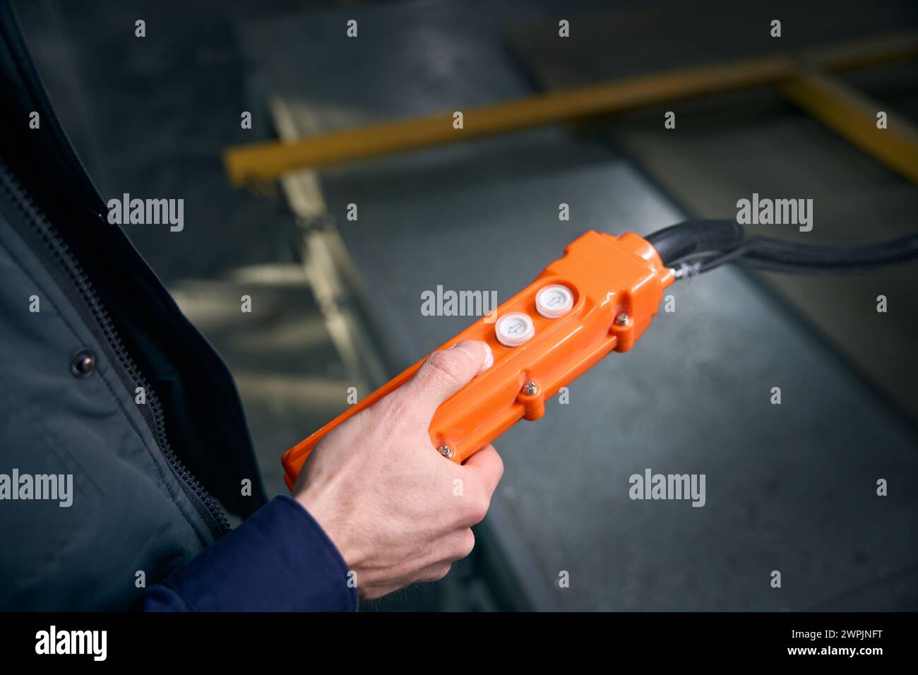Worker in the workshop holds in his hands control panel Stock Photo