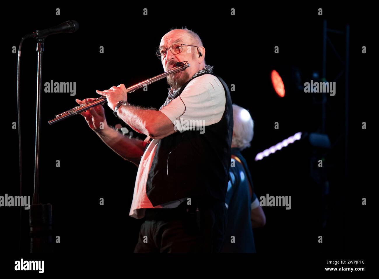 Ian Anderson is playing the flute on stage with his band Jethro Tull at