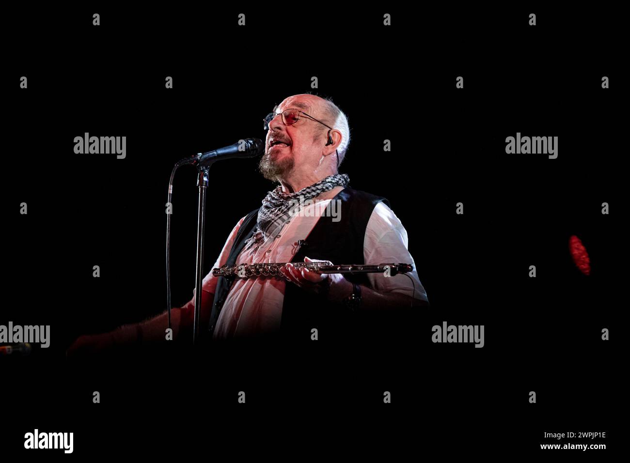 Ian Anderson is playing the flute on stage with his band Jethro Tull at