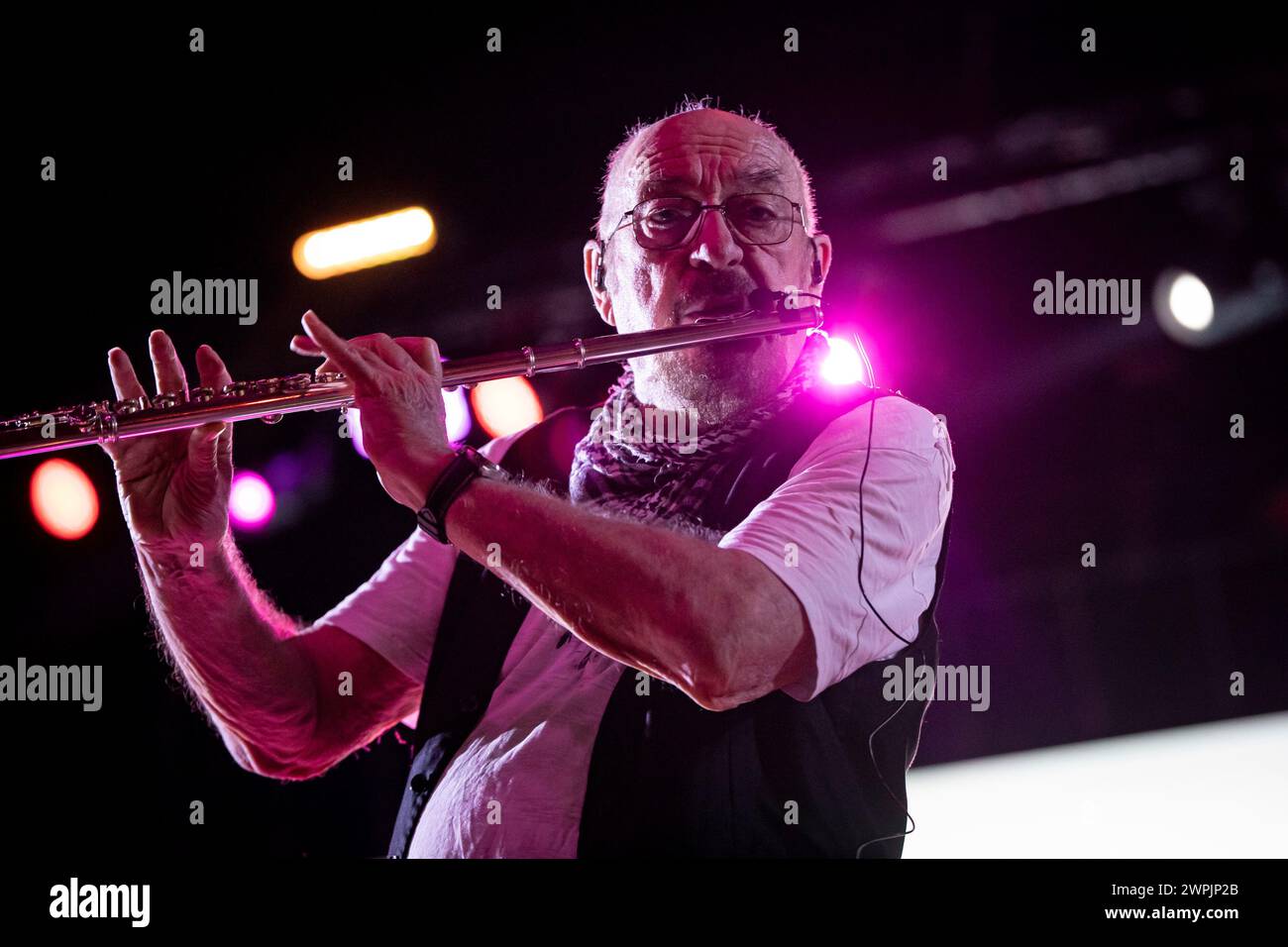 Ian Anderson is playing the flute on stage with his band Jethro Tull at