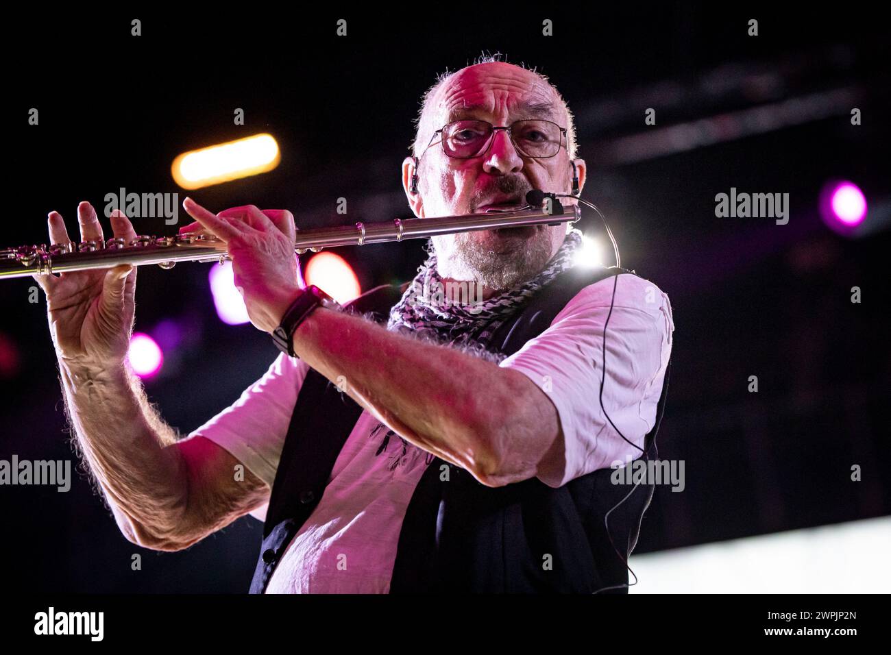 Ian Anderson is playing the flute on stage with his band Jethro Tull at