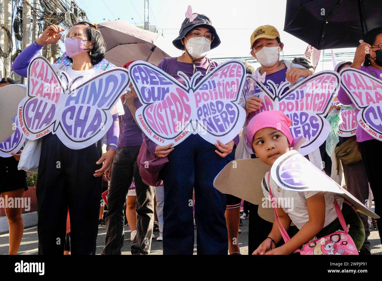 Womens groups scuffle with police while protesting on International Womens Day Members of various womens groups and progressive organizations scuffle with the police force while marching toward Mendiola Peach Arch in Manila, Philippines, 8 March 2024. The groups plan to conduct their program in Mendiola, a protest area near the Malacanang Palace but barred by riot police along Nicanor Reyes St., in Manila. The groups proceeded with the program to highlight the issues facing Filipino Women such as landlessness, low wages, and the plan of President Ferdinand Marcos Jr. to push for a Charter Chan Stock Photo