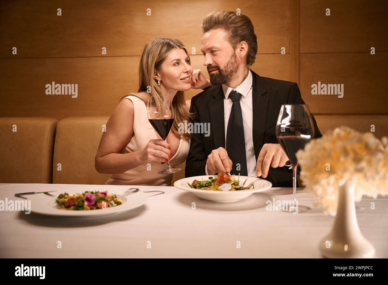 Middle-aged couple communicates over a romantic dinner in a restaurant Stock Photo