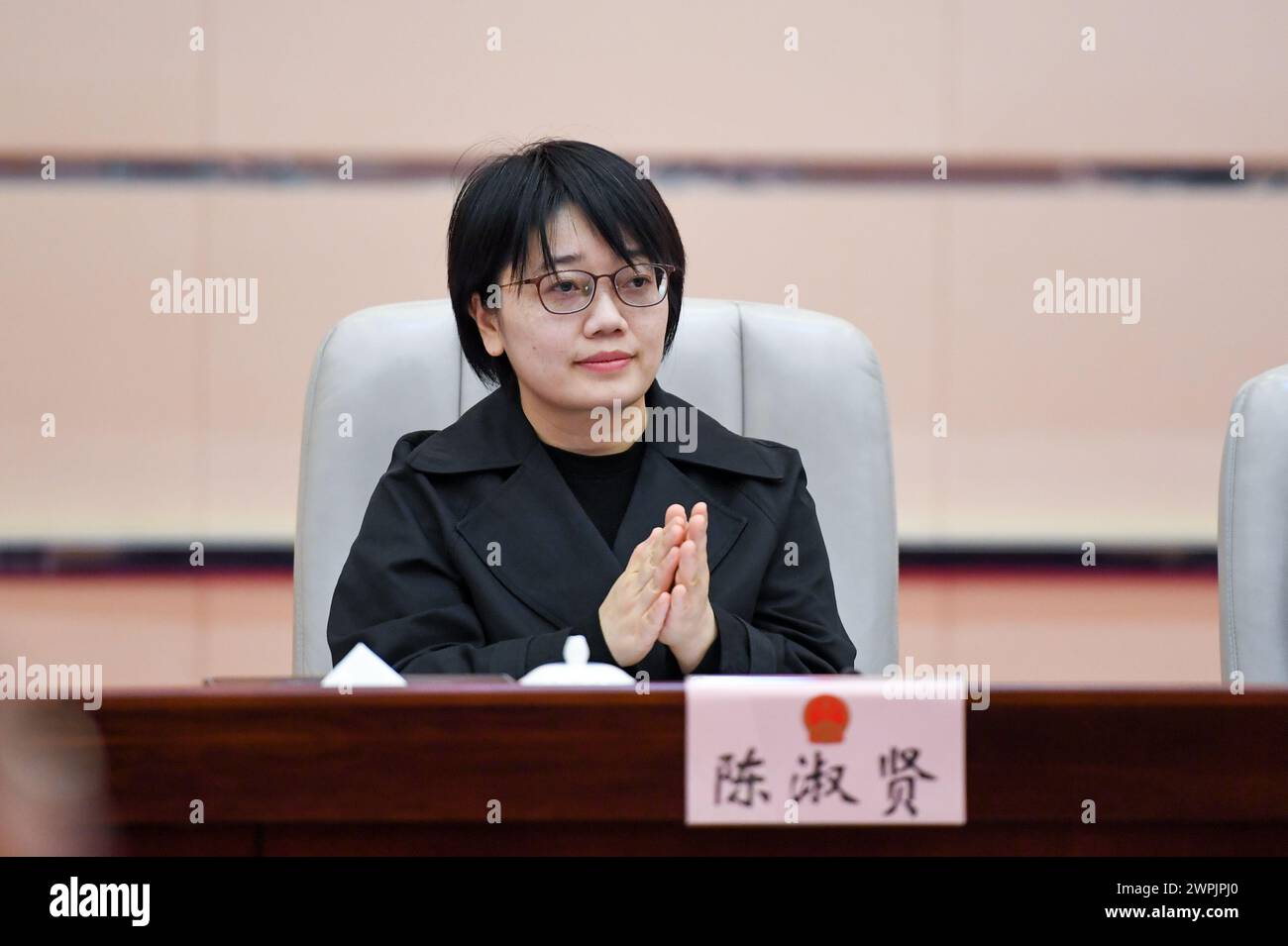 (240308) -- SHENZHEN, March 8, 2024 (Xinhua) -- Chen Shuxian attends a meeting at the Municipal People's Congress of Shenzhen, south China's Guangdong Province, Feb. 26, 2024. Chen Shuxian is a technical director of the wireless software test group of Shenzhen SED Wireless Communication Technology Co., Ltd. Her office is filled with small brick-like handhelds, which are mainly used for wireless communication in rail traffic. 'I feel a sense of fulfillment every time I see the conductors of high-speed trains using the handhelds,' Chen said. After joining the company in 2008, Chen participat Stock Photo