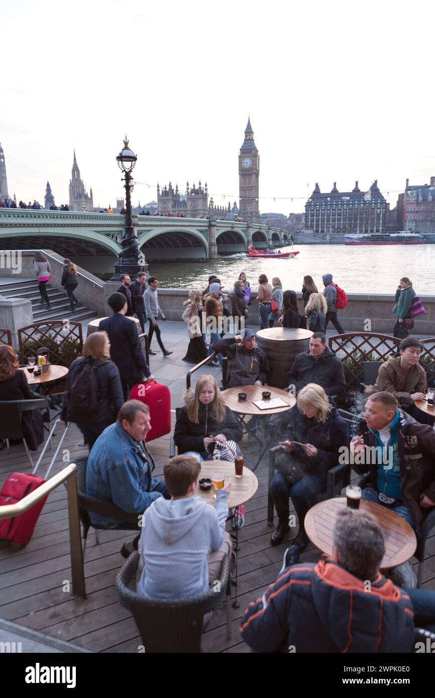 UK, London, people enjoying a drink at the County Hall Arms with Westminster in the background. Stock Photo