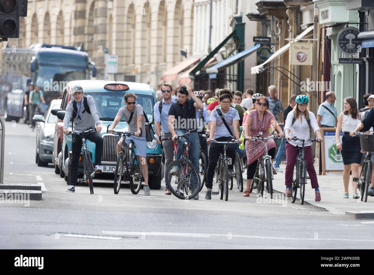 UK, Oxfordshire, Oxford, cyclists, taxi and pedestrians along high street. Stock Photo