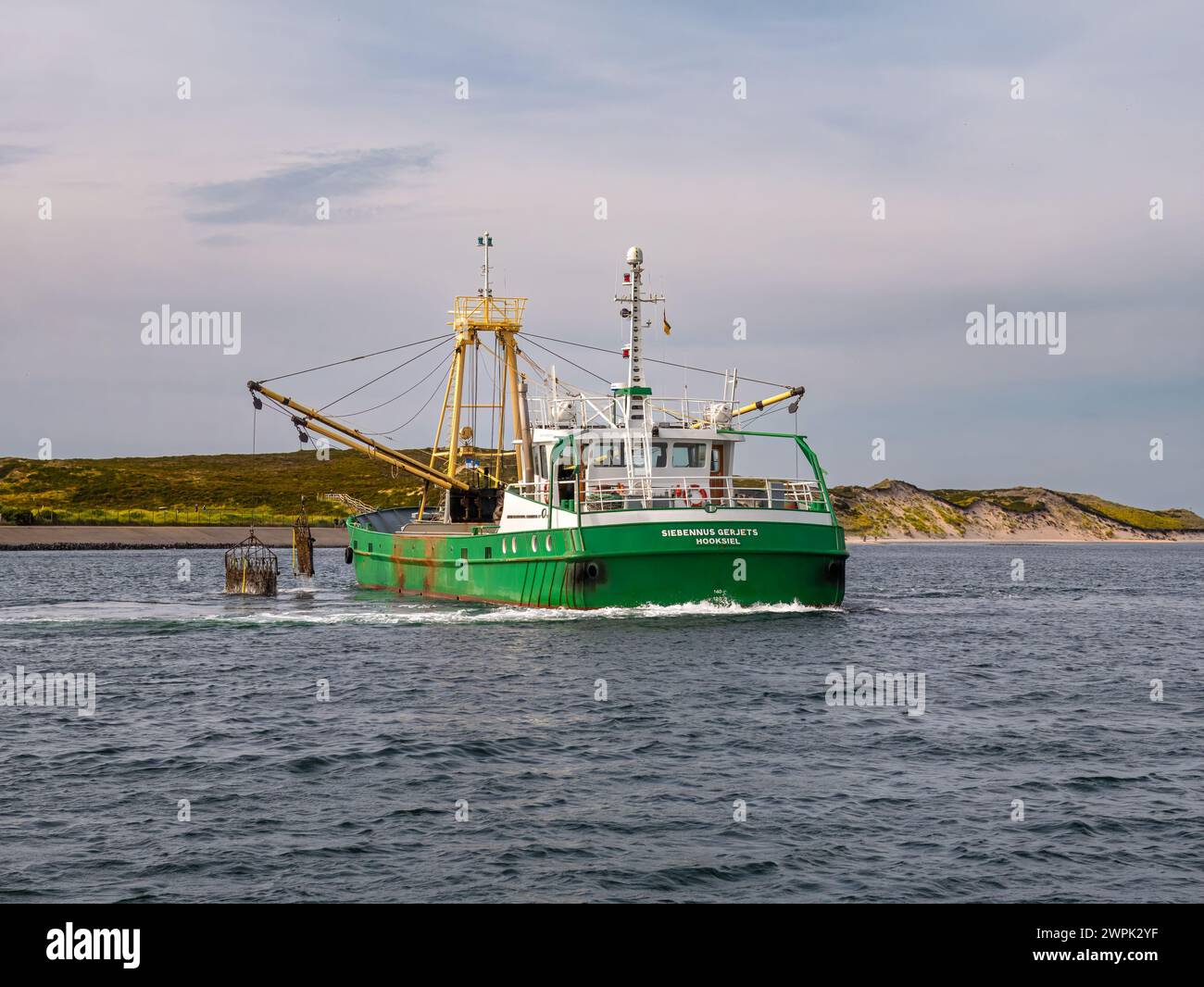 Fishing boat dredging for shellfish in Wadden Sea near Sylt island, North Frisia, Schleswig-Holstein, Germany Stock Photo
