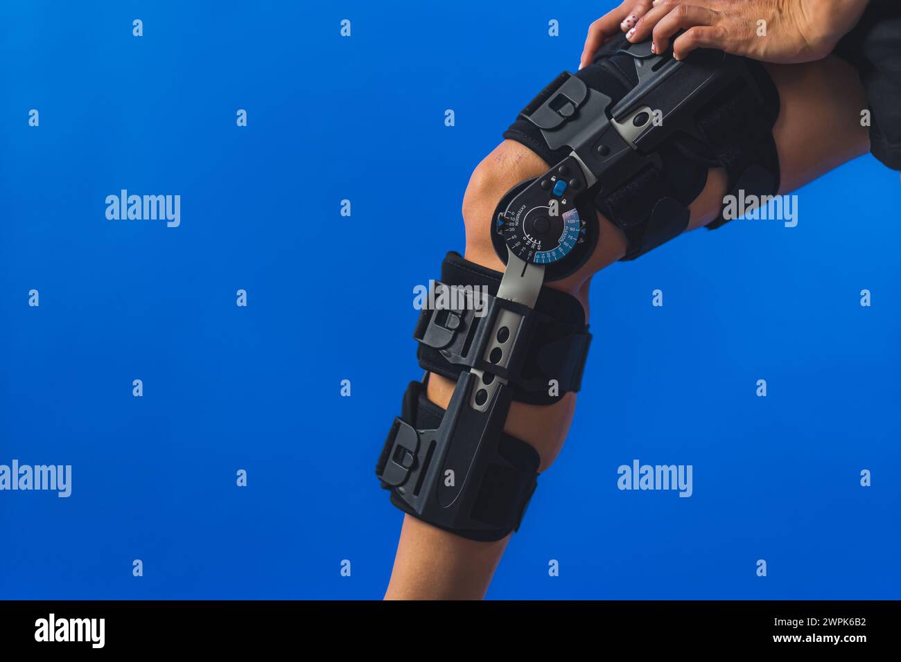 woman patient with modern bandage compression knee brace which has an ...