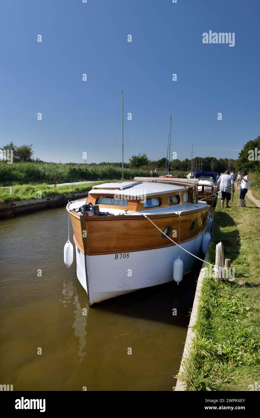 traditional wooden norfolk broads hire cruiser moored  horsey norfolk england Stock Photo