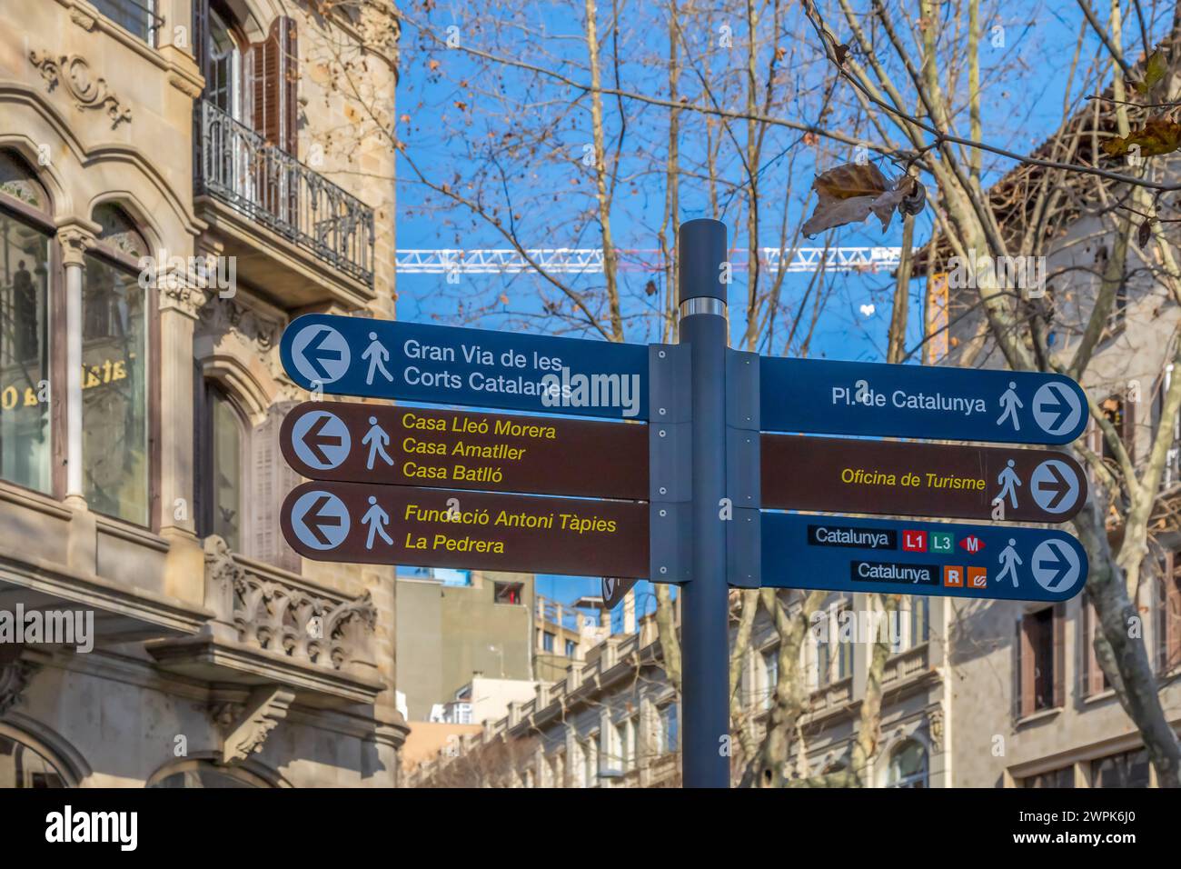 BARCELONA, SPAIN - FEBRUARY 27, 2022: Street signs marking the direction to the famous sites to visit in Barcelona. Historic district. Stock Photo