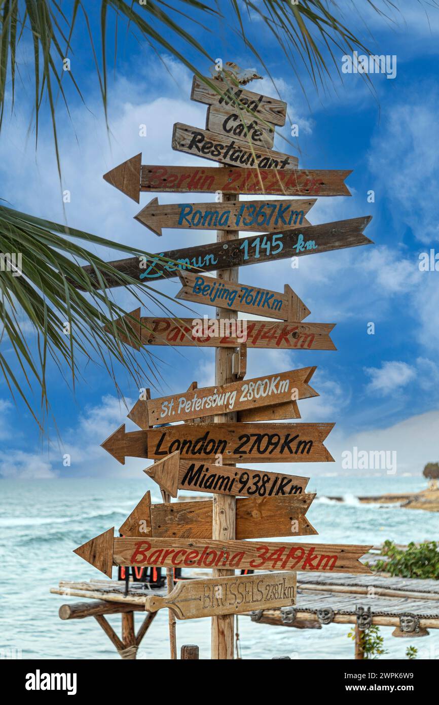 Hersonissos, Crete, Greece - July 23, 2021: Touristical and ornamental signs marking the direction and distance to famous cities in the world. Stock Photo