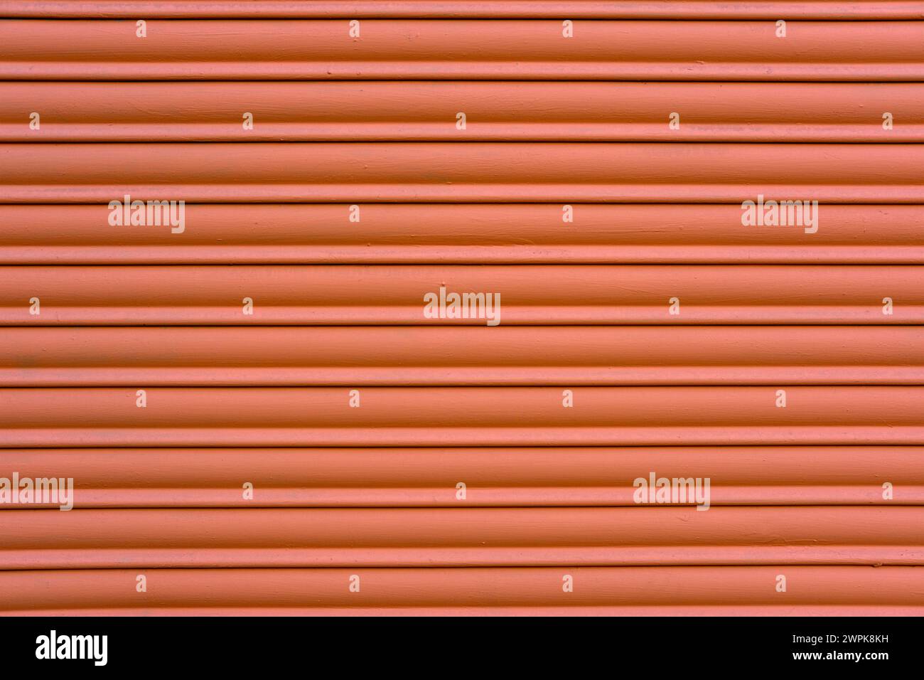 Background from a red painted roller shutter of a shop Stock Photo