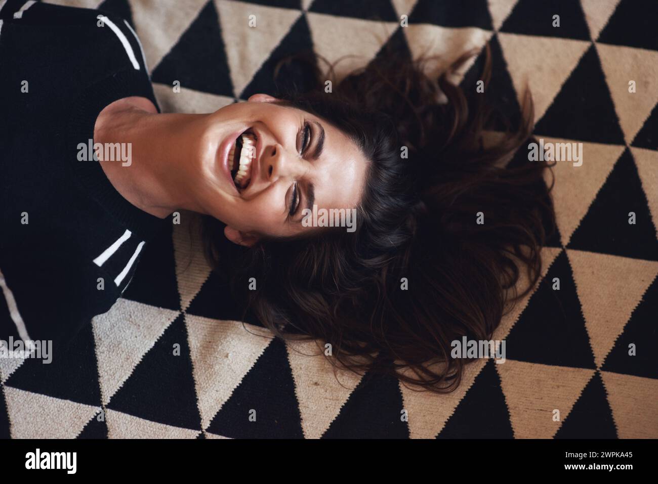 Woman, lying or laugh in beauty, fashion and designer style as monochrome, abstract or aesthetic. Smile, female person and glow as luxury, pattern or Stock Photo