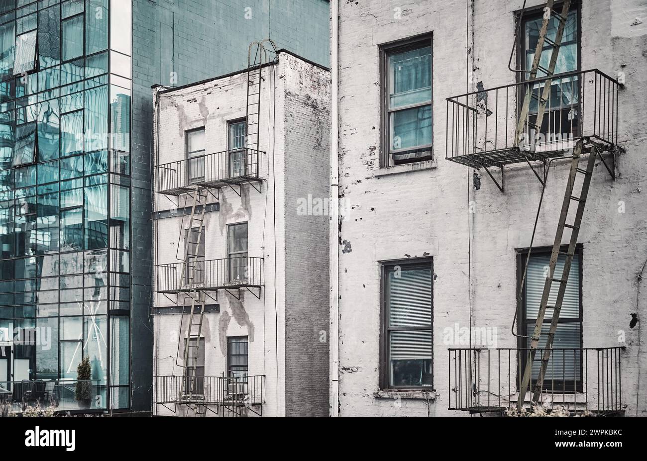 Old buildings with fire escapes, color toning applied, New York City ...