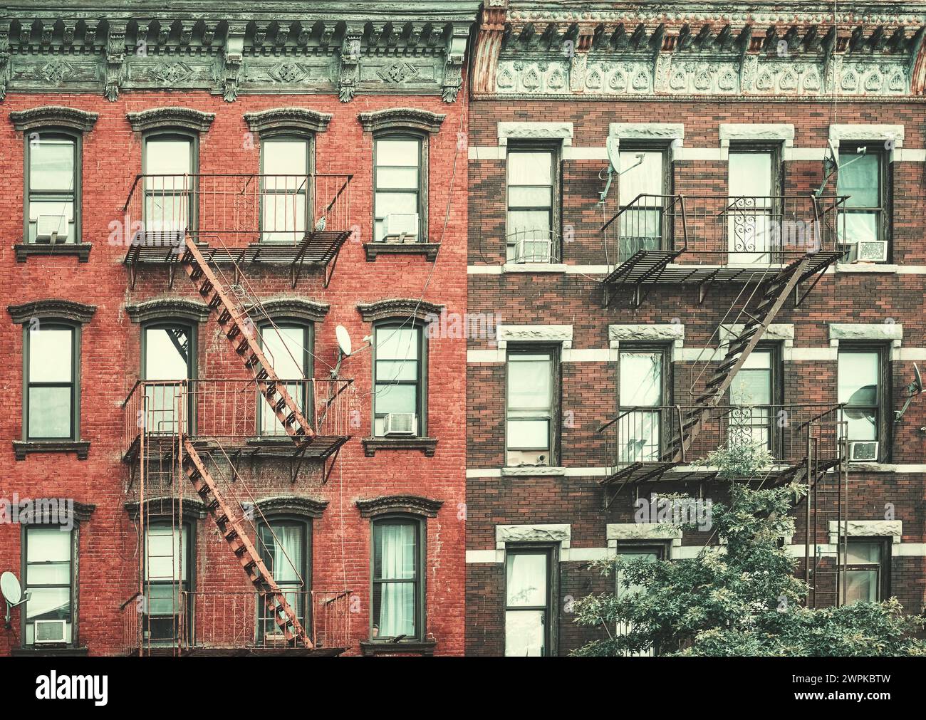 Old buildings with fire escapes, color toning applied, New York City ...