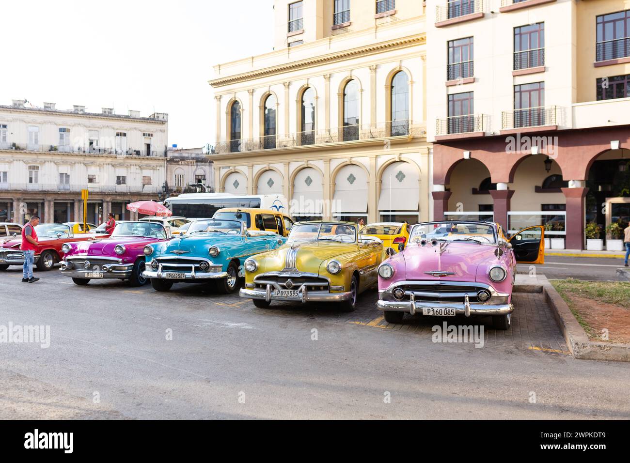 Pink, blue, and yellow convertibles in Havana Cuba Stock Photo