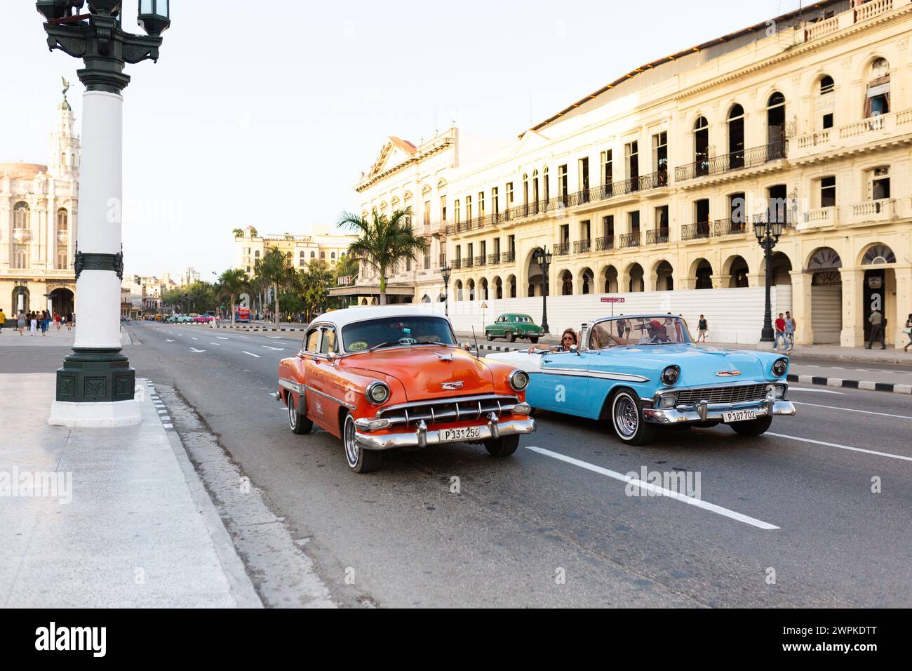 Red and blue cars driving on Havana's streets Stock Photo