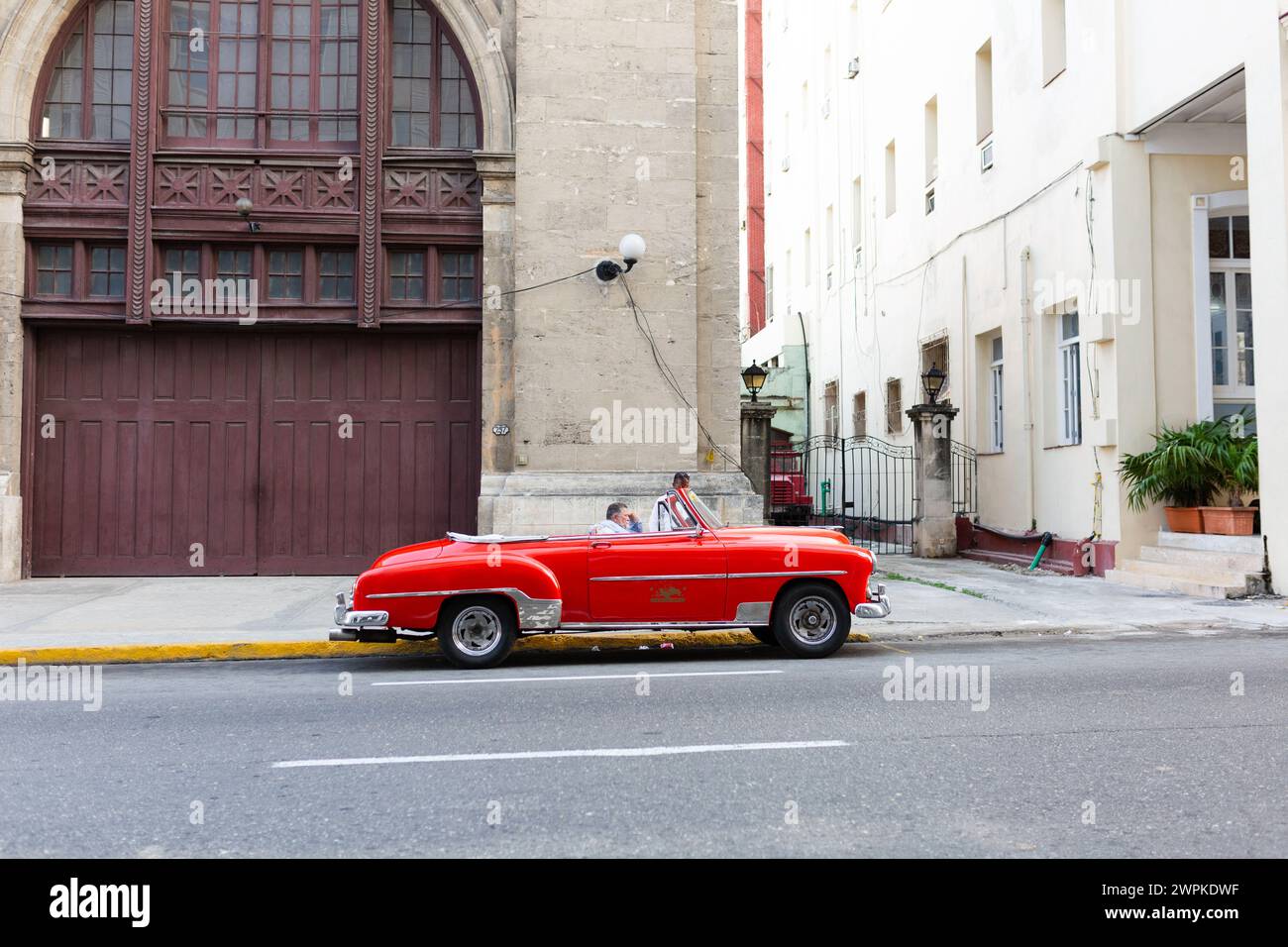 Vintage crimson car at the fire station in Havana Cuba Stock Photo