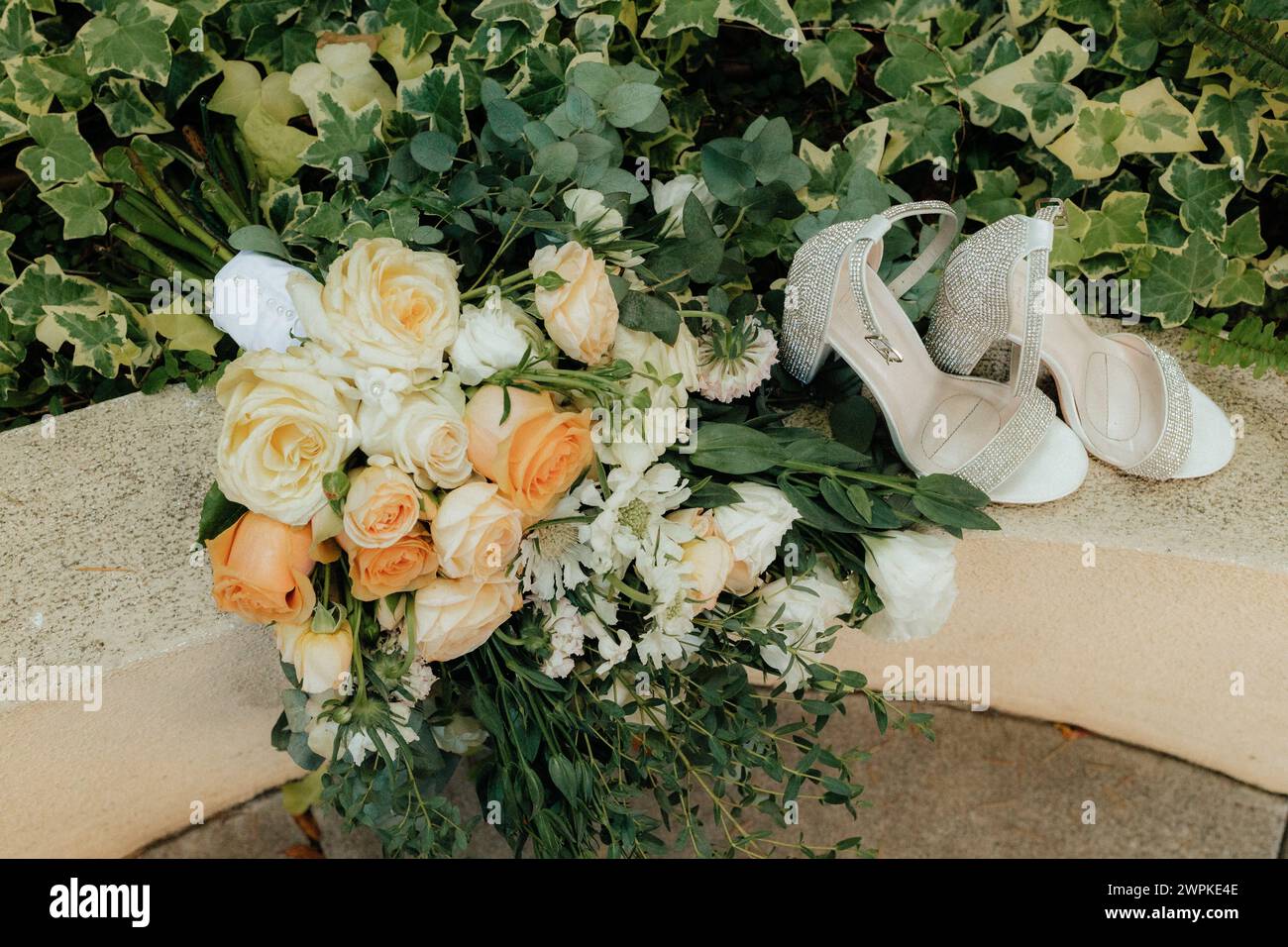 Wedding shoes and wedding florals Stock Photo