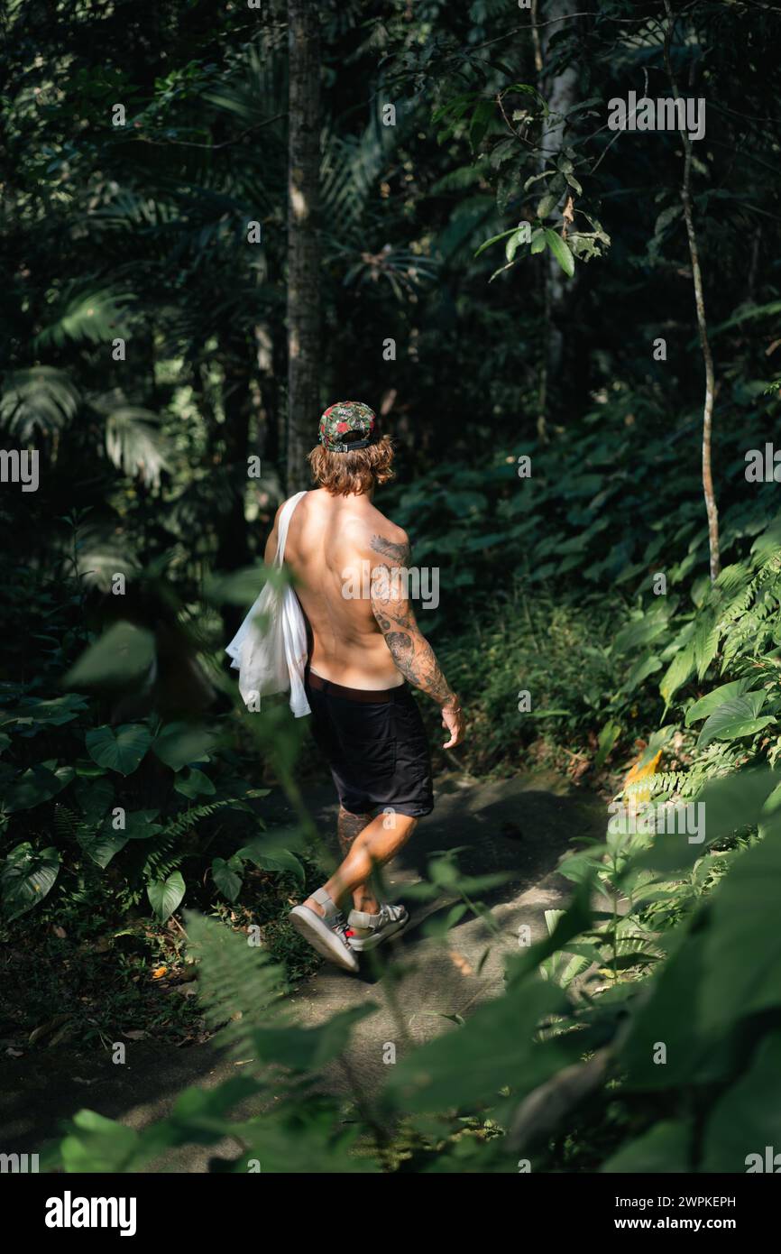 Young man traveler in the tropical jungle. Stock Photo