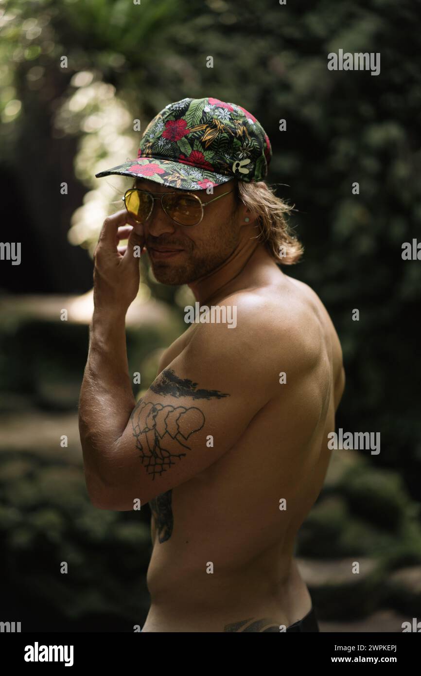 Young man traveler in the tropical jungle. Stock Photo