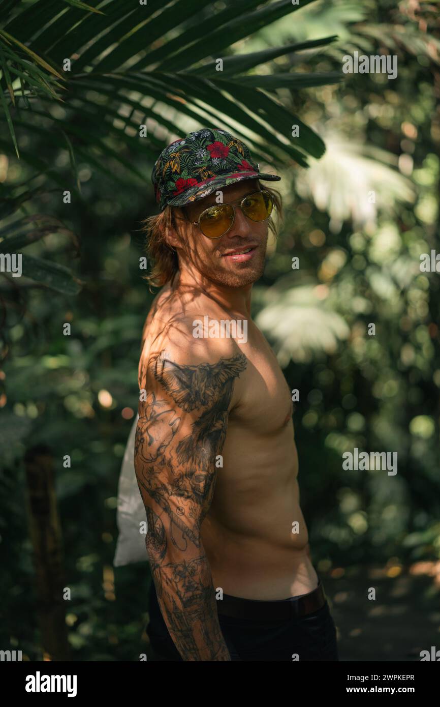 Young man traveler in the tropical jungle. Stock Photo