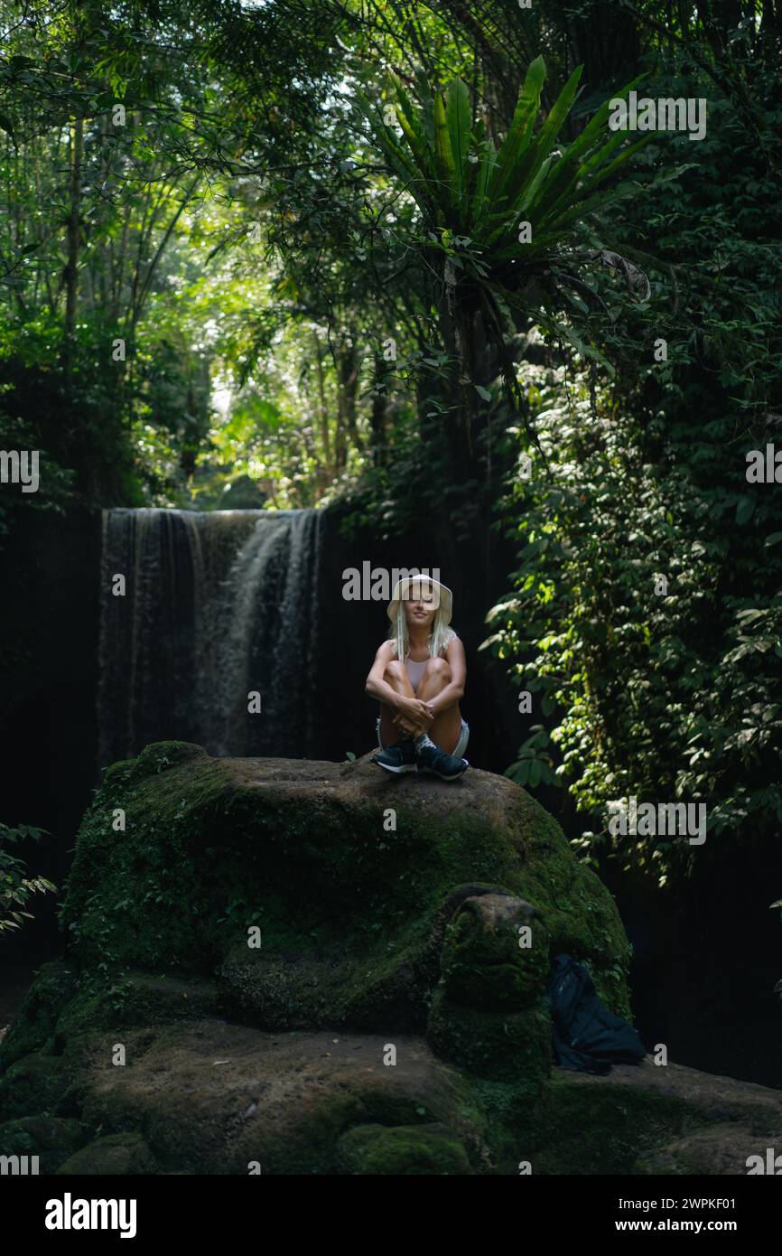 Woman traveler at Suwat waterfall in the jungle Bali Stock Photo - Alamy