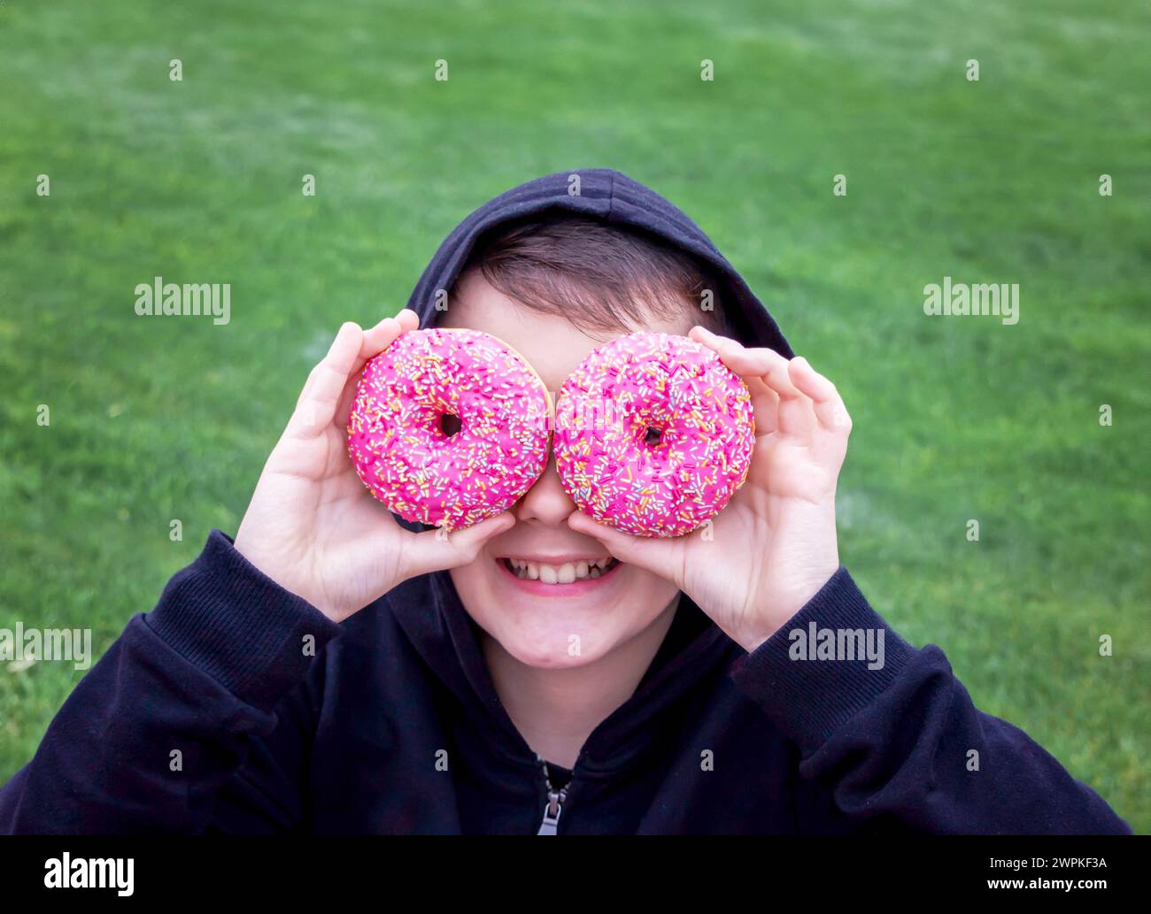 Child have fun with donuts Stock Photo