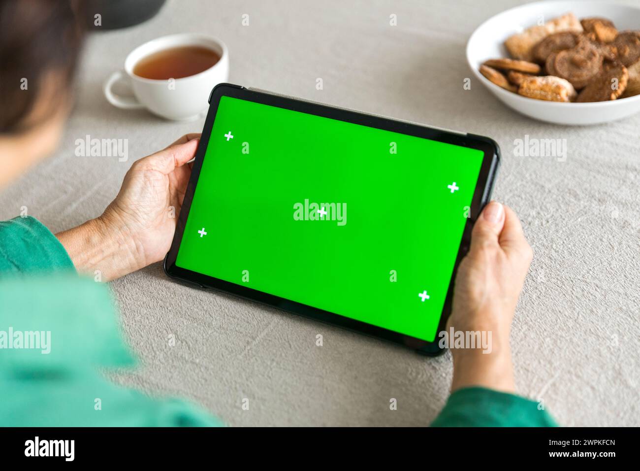 tablet with green screen chromakey display in elderly woman hand Stock Photo