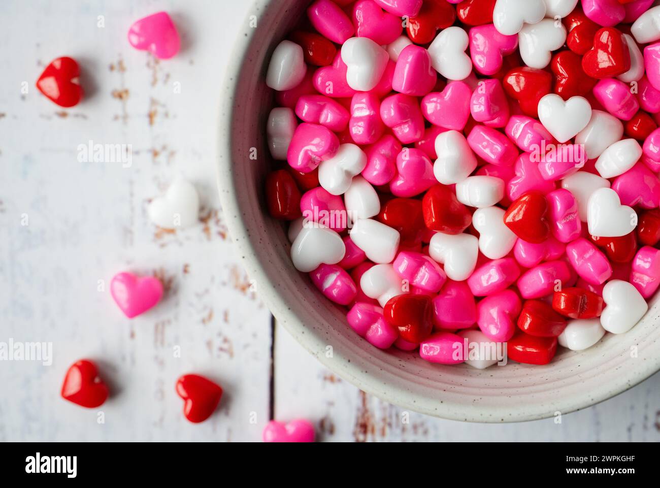 Bowl of small red, pink, white candy hearts for Valentine's Day. Stock Photo