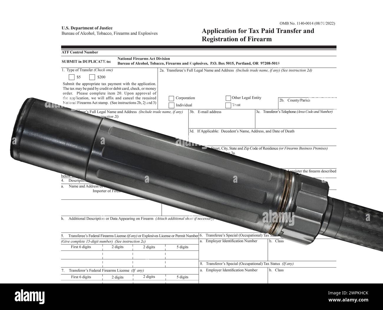 ATF public domain tax form behind a suppressor mounted on a gun barrel ...