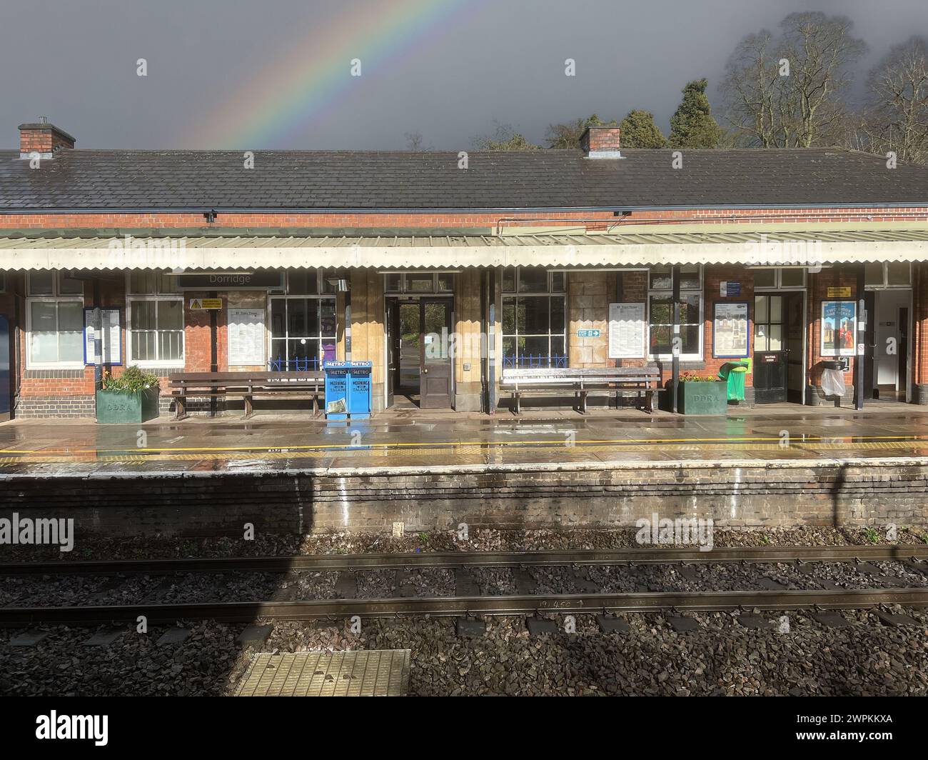 British Network Rail passenger commuter suburban station West Midlands England UK Rainbow over tracks. Stock Photo