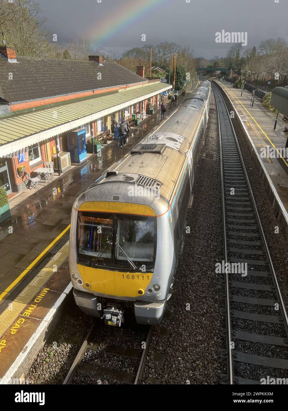 British Network Rail passenger commuter suburban station West Midlands England UK Rainbow over tracks. Stock Photo