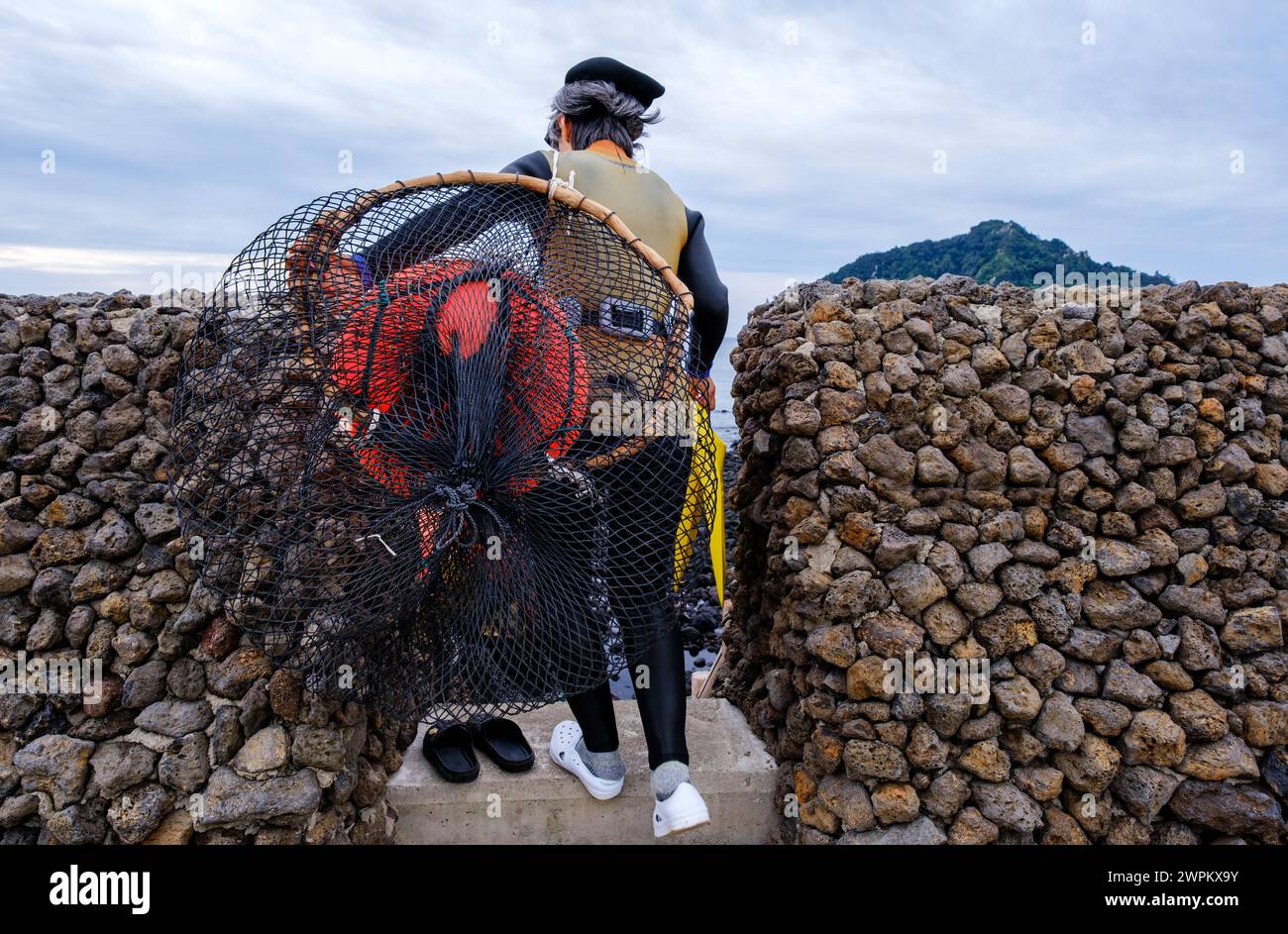 Haenyeo divers, famous for diving into their eighties and holding their breath for up to two minutes, diving for conch, octopus, seaweed Stock Photo