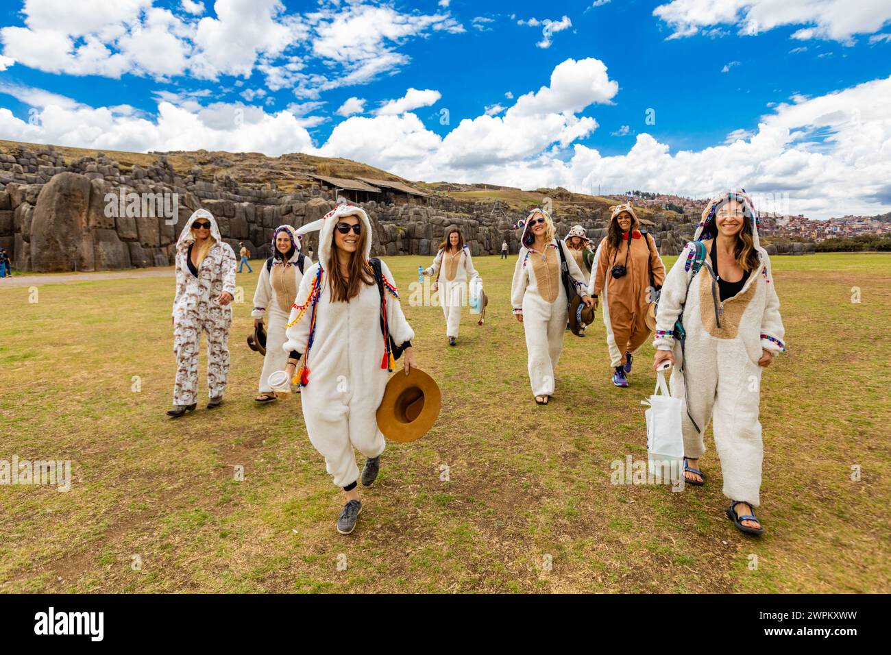 Women dressed in alpaca llama onesies in Cusco, Peru, South America Stock Photo