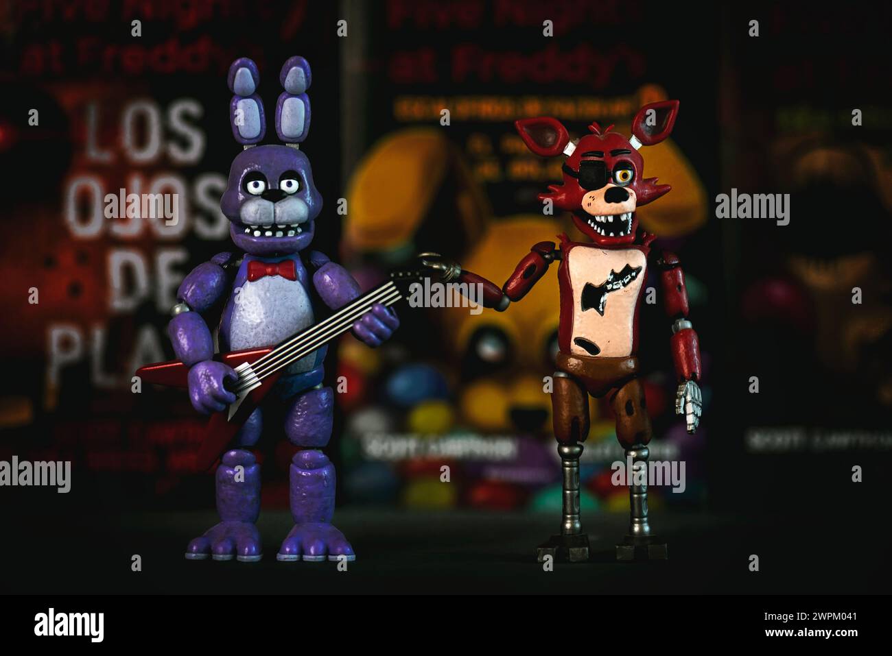 Figures of Bonnie and Foxy characters of the videogames,movies and books Five Nights at Freddy's in front of books. Illustrative editorial Stock Photo