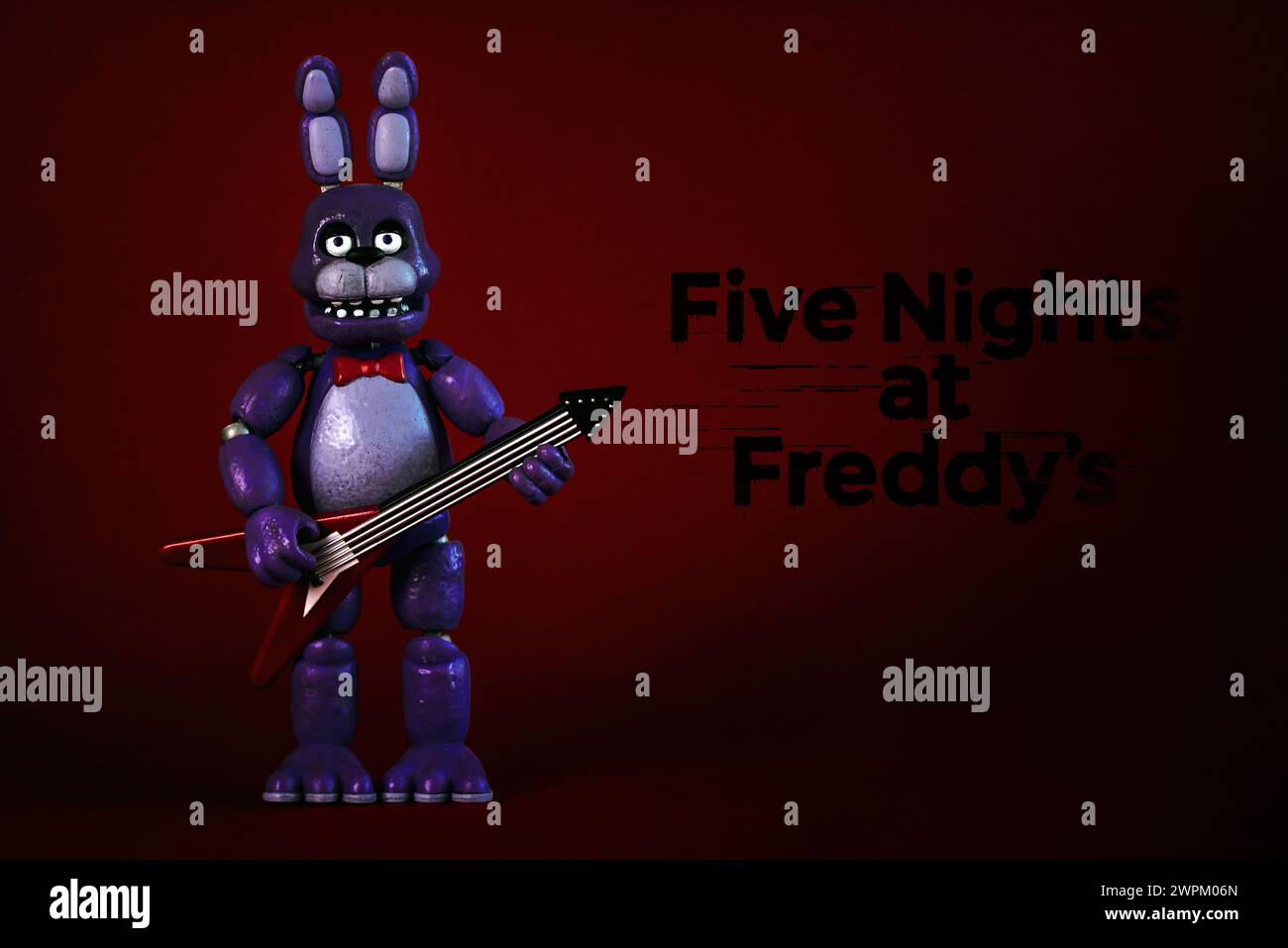 Figure of Bonnie character of the videogames,movies and books Five Nights at Freddy's and logo over red background. Illustrative editorial Stock Photo