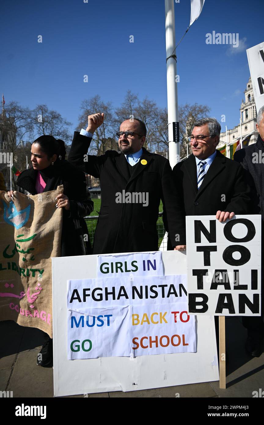 Parliament square, LONDON, ENGLAND - MARCH 08 2024. On International Women's Day, March 8th (IWD), women around the globe are not celebrating but protesting for women's rights. The ACAA staged a protest in Parliament Square to highlight the voices of women in Afghanistan who are subjected to serious human rights violations by the Taliban. Also, the highlight is that the Americans lost the war in Afghanistan. The US government is the biggest violated of democracy and human rights has stolen 8 billion US dollars from Afghan civilians. Many Afghan families are forced to sell their children and ma Stock Photo