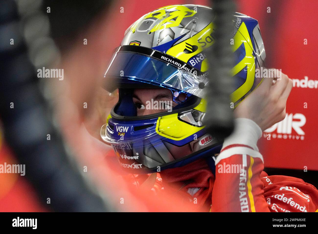 British Ferrari driver Oliver Bearman wears the helmet at pits prior to ...