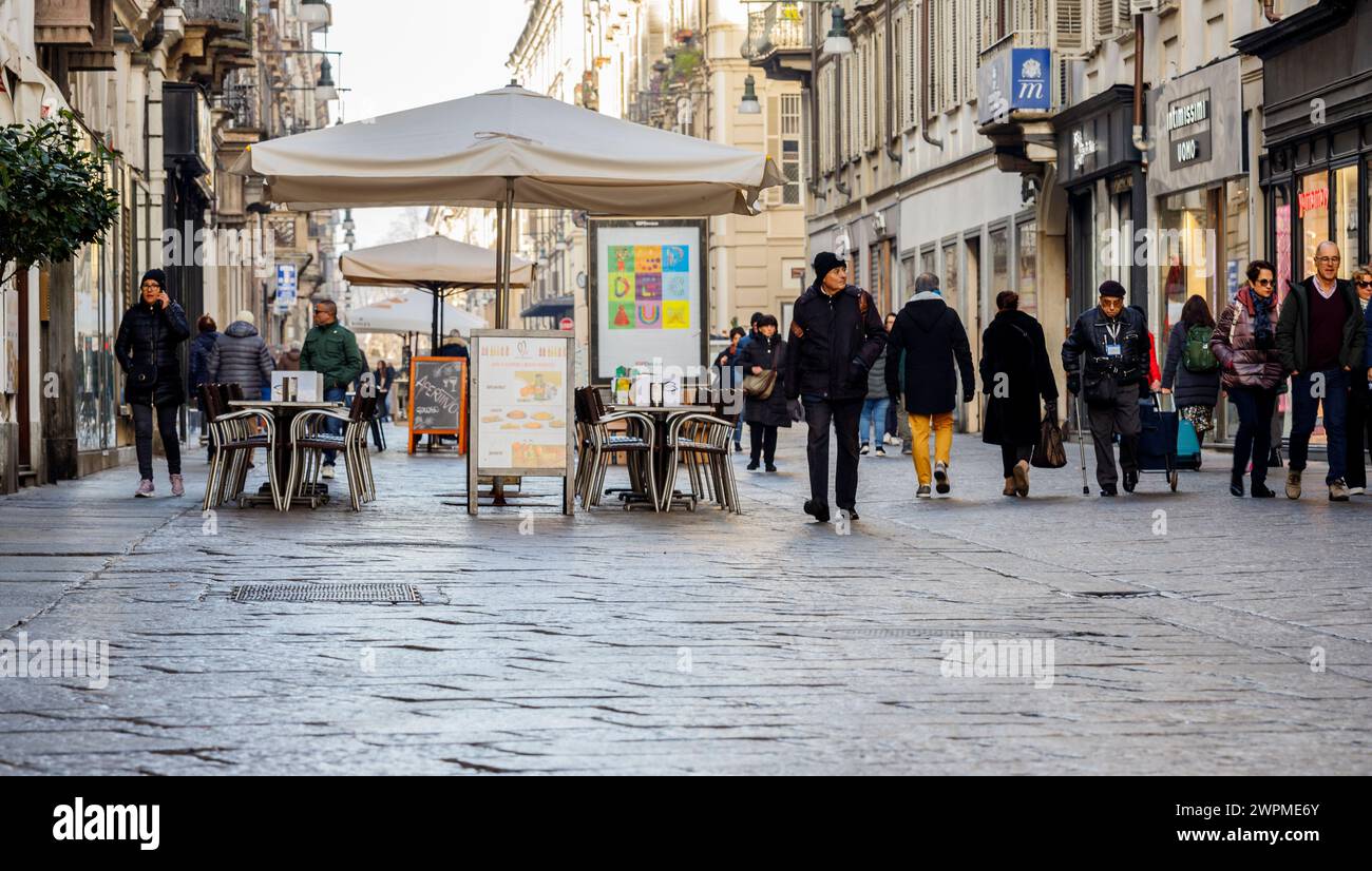 Turin, Piedmont, Italy - February 2, 2024: People walking down a street in the old town (via Garibaldi). Stock Photo