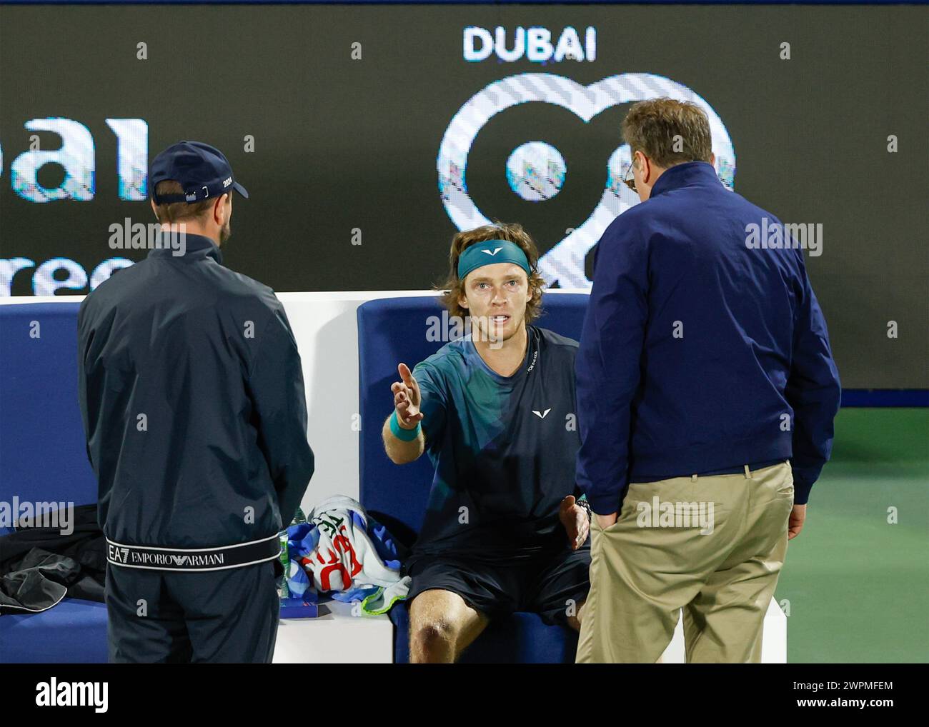 Andrey Rublev being informed by the ATP supervisor that he has been defaulted for using abusive language towards a linesperson at the Dubai Duty Free Stock Photo