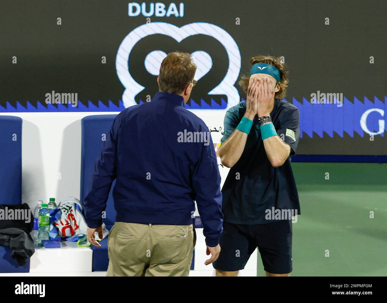 Andrey Rublev being informed by the ATP supervisor that he has been defaulted for using abusive language towards a linesperson at the Dubai Duty Free Stock Photo