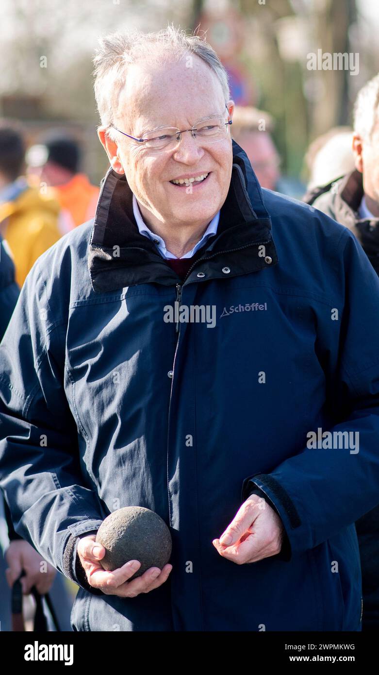 Aurich, Germany. 08th Mar, 2024. Stephan Weil (SPD), Minister President of Lower Saxony, holds a Boßel ball in his hand. Stephan Weil put his throwing skills to the test in this popular East Frisian street sport at the traditional 'Landschaftsboßeln'. Credit: Hauke-Christian Dittrich/dpa/Alamy Live News Stock Photo