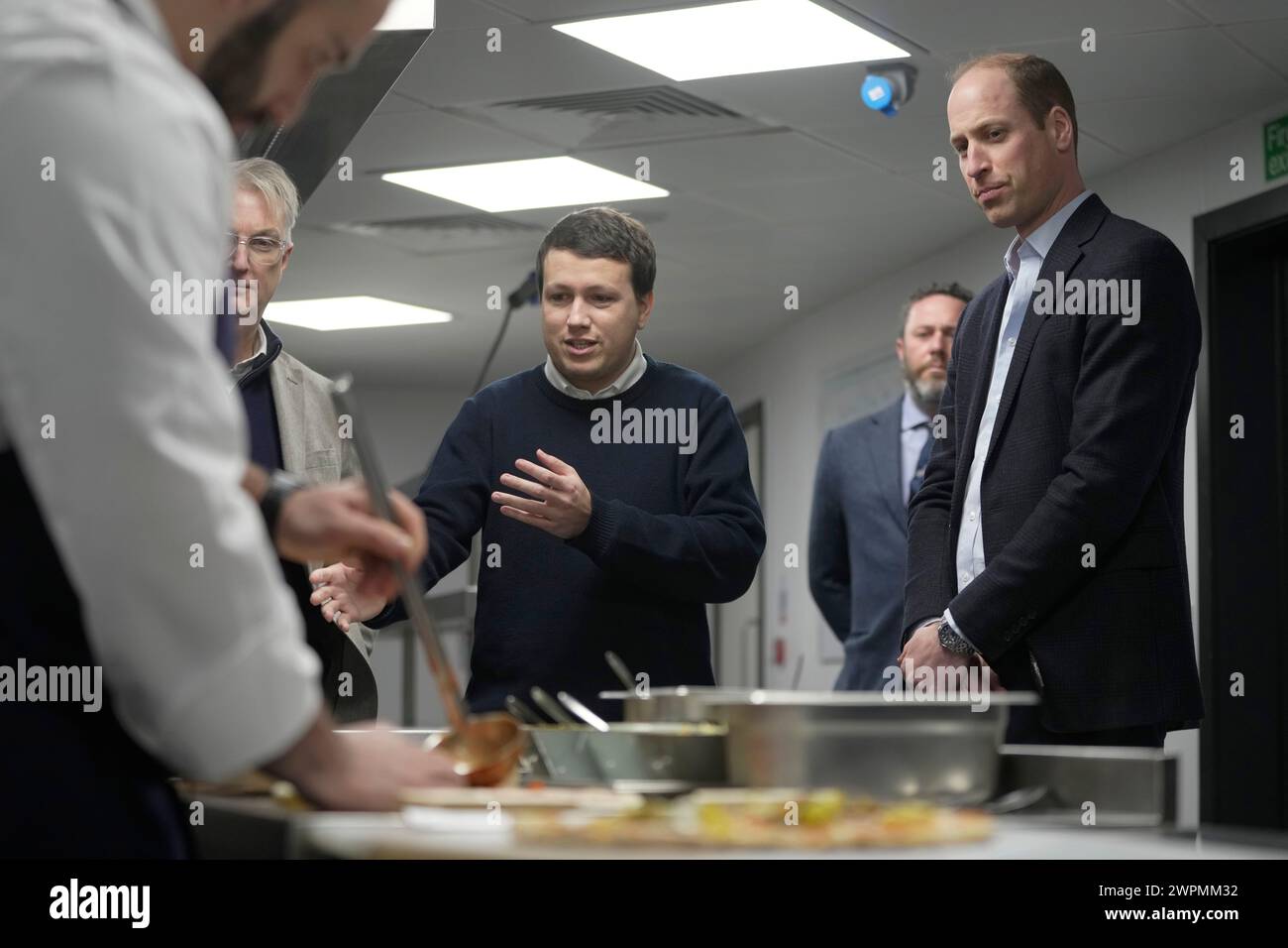 Prince William, right looks on as to PierreYves Paslier cofounder of