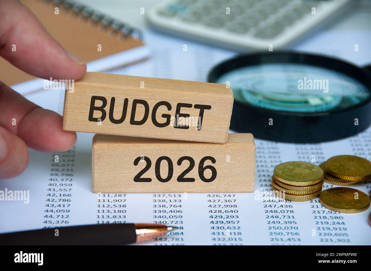 Hand holding wooden block with text - Budget 2026 with financial data ...