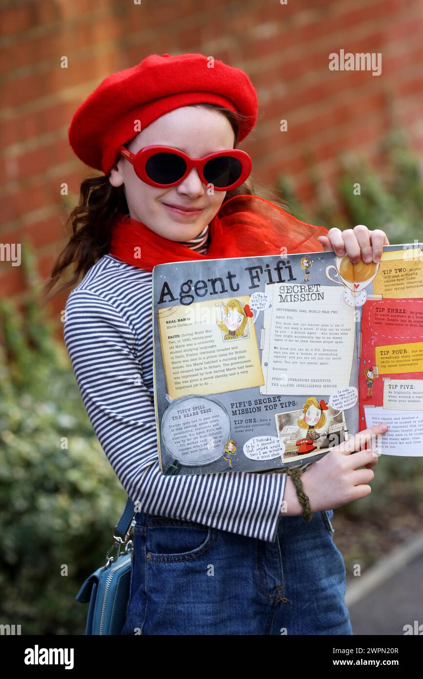 A young girl dressed up as Agent Fifi for World Book Day in West Sussex, UK. Stock Photo