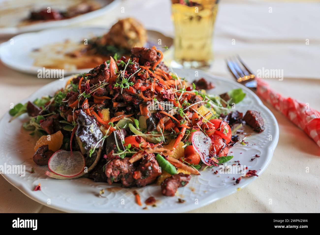 Austrian salad speciality in autumnal game season - colorful fresh salad with grilled wild pheasant pieces Stock Photo