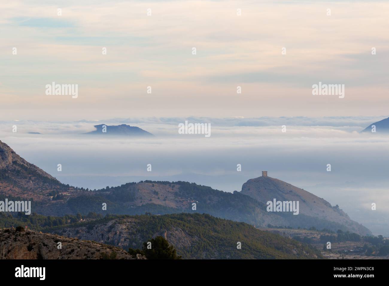 Foggy landscape of Cocentaina mountain and Cocentaina valley during a winter morning, Spain Stock Photo